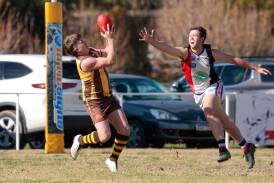 East Wagga-Kooringal's Jeremy Piercy takes a strong mark despite the best efforts of North Wagga defender Ky Hanlon in the Farrer League game at Gumly Oval on Saturday. Picture by Bernard Humphreys