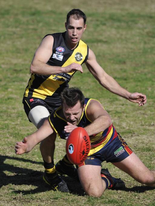 TIGHT CONTEST: Leeton-Whitton's Michael Wescombe and Wagga Tigers' James Richards compete for the ball in Saturday's Riverina League qualifying final at Narrandera Sportsground. Picture: Les Smith