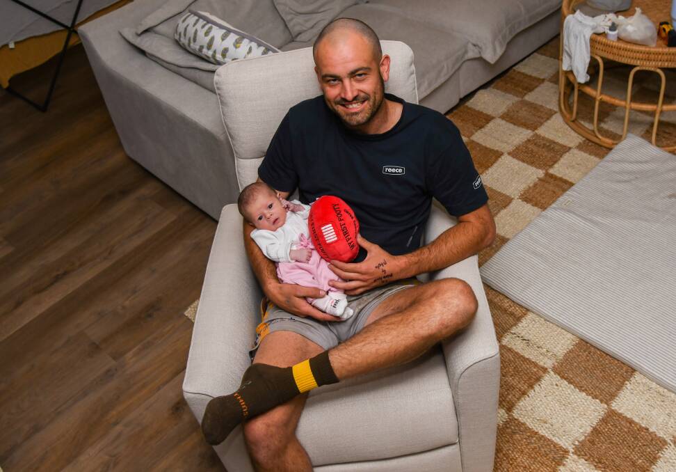 East Wagga-Kooringal forward Brocke Argus with five-day-old daughter Aria at home on Thursday. Picture by Bernard Humphreys
