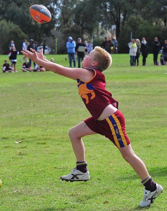 COME HERE: Ganmain's Albert Booth chases after the ball in the game against Mater Dei Primary School at Jubilee Park on Thursday. Picture: Kieren L Tilly
