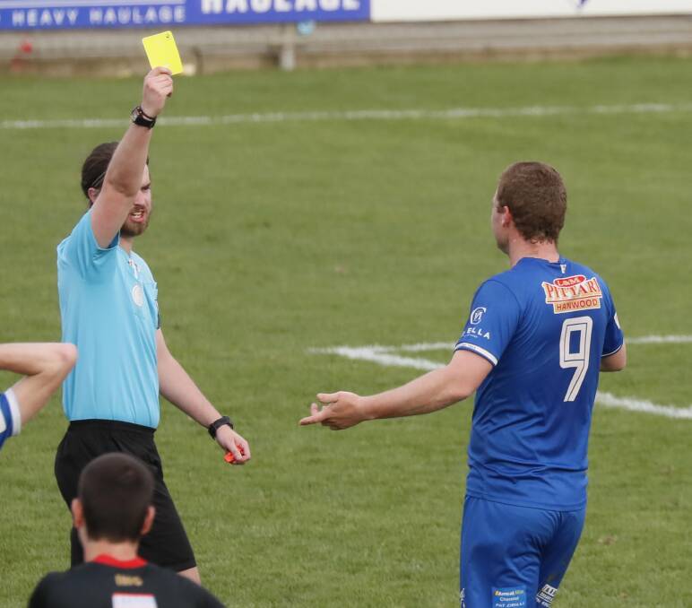 Referee Thomas Manton issues a yellow card to Hanwood's Daniel Johnson in the first half of Sunday's Pascoe Cup grand final. Picture by Les Smith