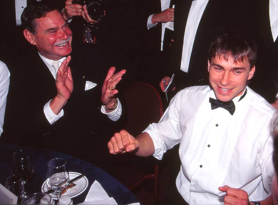 Wagga's Paul Kelly celebrates his 1995 Brownlow Medal win alongside his Sydney Swans coach Ron Barassi (left), who passed away last Saturday. Picture by Getty Images