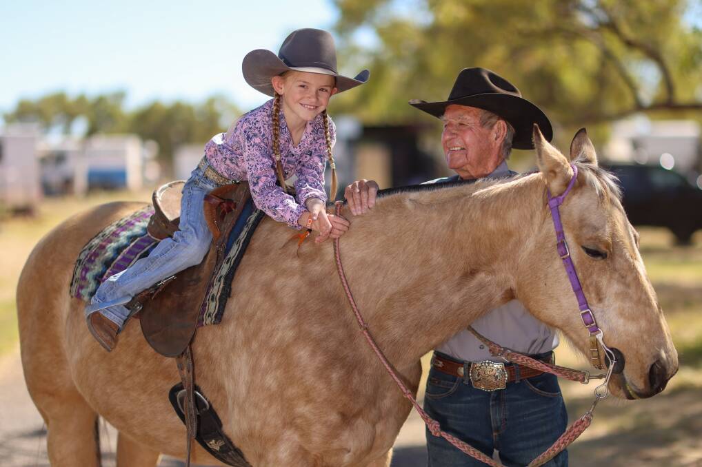 One of Mount Isa Rodeo's youngest competitors, Tooma's Katie Pierce, 8, with the world's oldest and Cootamundra cowboy Bob Holder, 92, who competed with her great-grandfather. Picture contributed