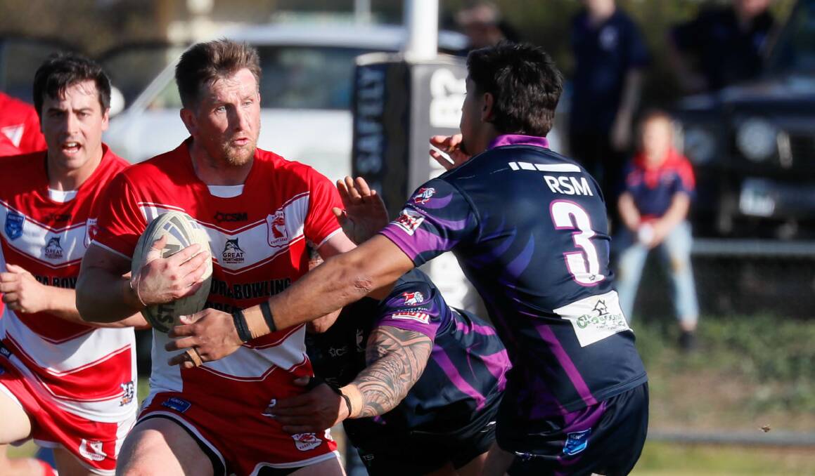 Josh McCrone tries to fend off the Southcity defence as Temora's win at Harris Park on Sunday wrapped up the Group Nine minor premiership. Picture by Les Smith