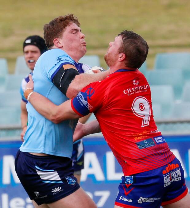 Hayden Jolliffe tries to bring down Michael Fenn in Kangaroos' loss to Tumut to start the finals series. Picture by Les Smith
