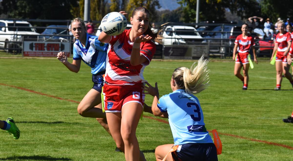 Nikola Henman gets a pass away under pressure from Courtney Barratt in Temora's win over Tumut at Twickenham on Saturday. Picture by Courtney Rees