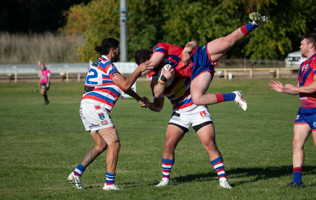 Ollie Hoskin gets lifted up by Ata Tupou as Kangaroos slipped to a 28-26 loss to Young at Alfred Oval on Sunday. Picture by Madeline Begley