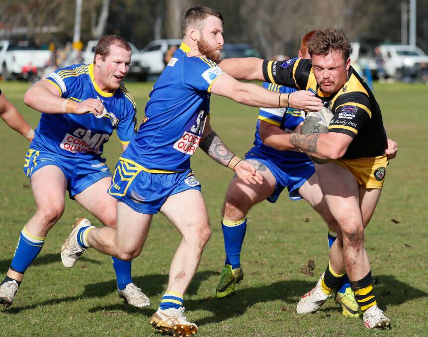 Jack Schubert tries to shrug out of Daniel Foley's tackle attempt during Gundagai's win over Junee at Laurie Daley Oval on Saturday. Picture by Les Smith