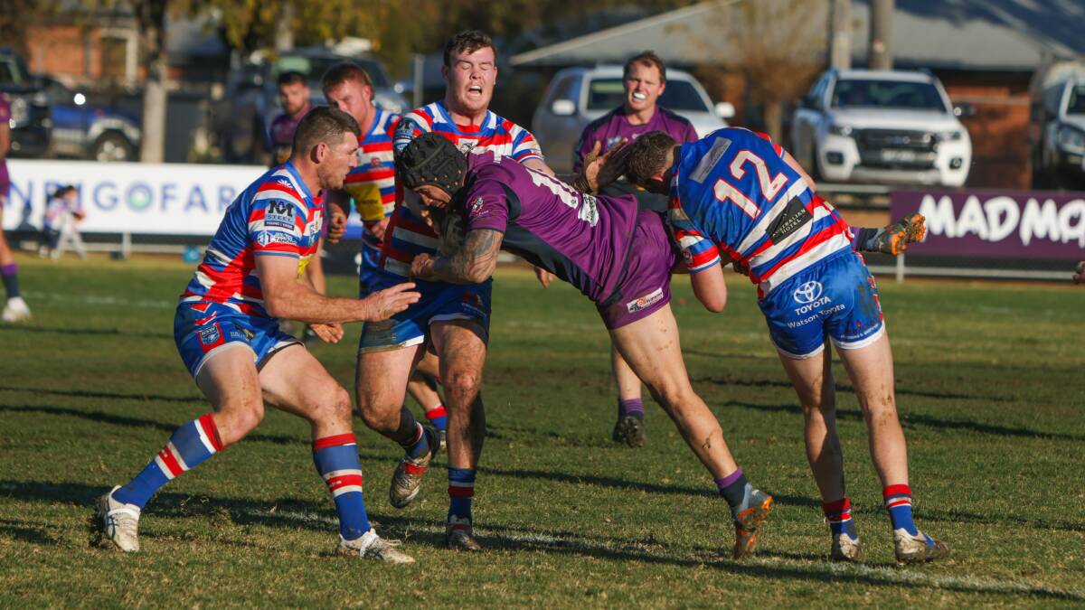 Dana Ratu is brought down by Aaron Slater, Ton Giles and Jake Kambos in Southcity's narrow loss to Young at Harris Park on Sunday. Picture by Tom Dennis