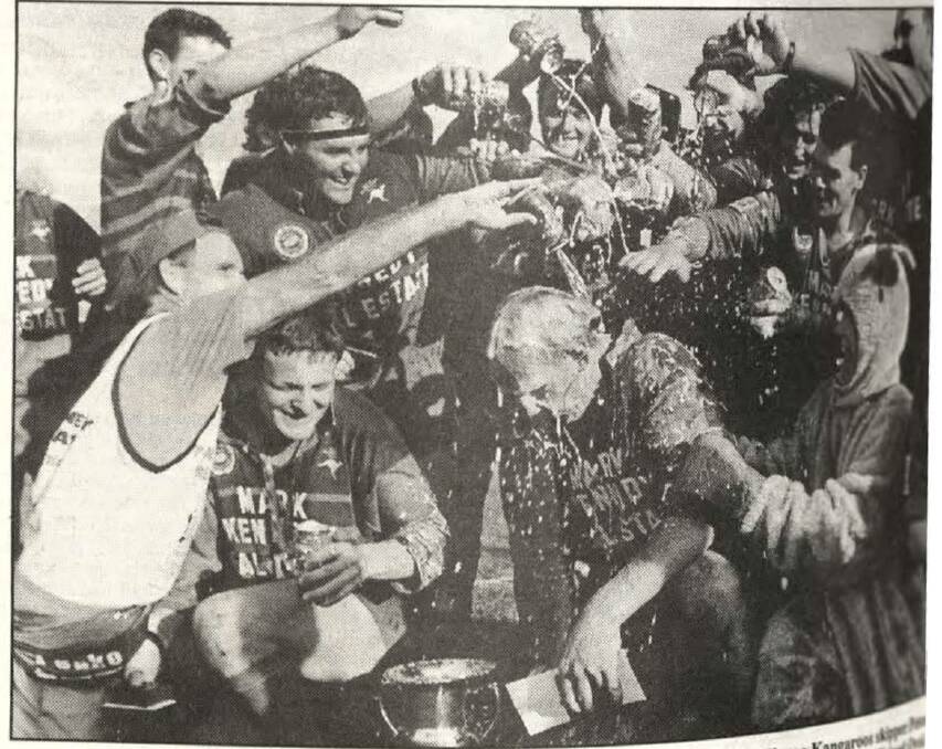 Captain-coach Peter McArthur is doused with beer as Kangaroos celebrate their 1994 grand final victory.