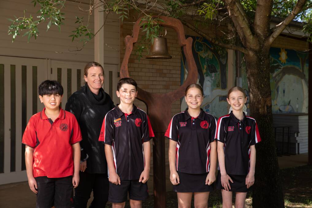  Sturt Public School principal Terri Inglis pictured with school captains Houston Zhang, Xavier Harper, Evie Killeen and Asha Forrell with the old school bell ahead of Saturday's 50th anniversary celebrations. Picture by Madeline Begley