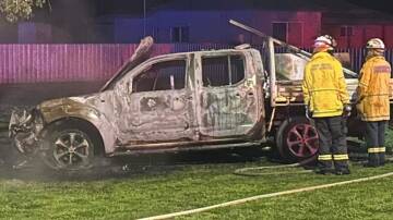 Firefighters extinguish a ute, which police said was stolen from Young, after it was found on fire in Cootamundra during the early hours of Thursday, July 25. Picture supplied