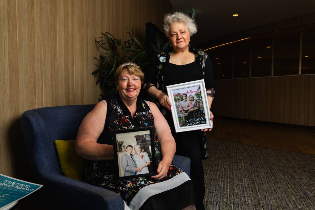 Wagga Ovarian Cancer Awareness Group co-chairpersons Tracey Page with a picture of her late mother and Judy-Ann Emberson holding a picture of her late sister. Picture by Ash Smith