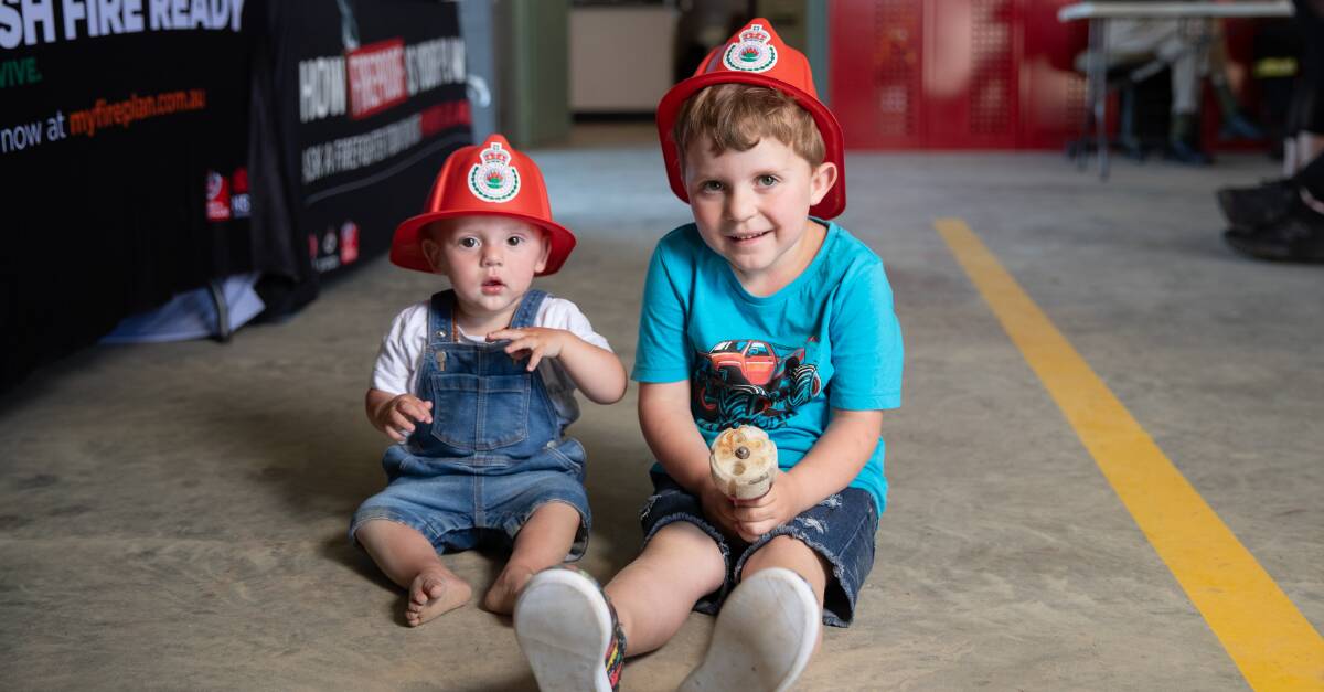 Wagga's Xavier Weymouth, 12 months, and big brother Jayden, 4, have fun at the Lake Albert Fire Brigade's 'Get Ready Day' on Sunday. Picture by Madeline Begley 