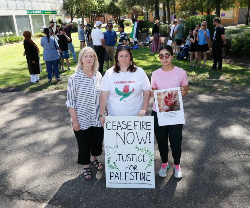 Wagga deputy mayor Jenny McKinnon (left) joins Jayne Christian and Zahraa Najem at a peace rally for Palestine near Riverina MP Michael McCormack's office on Sunday. Picture by Les Smith