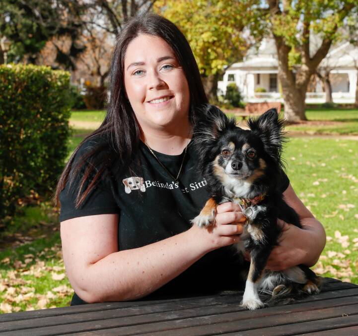 Wagga pet sitter Belinda Gardner with three-year-old chihuahua Charlie who she cares for. Picture by Les Smith 