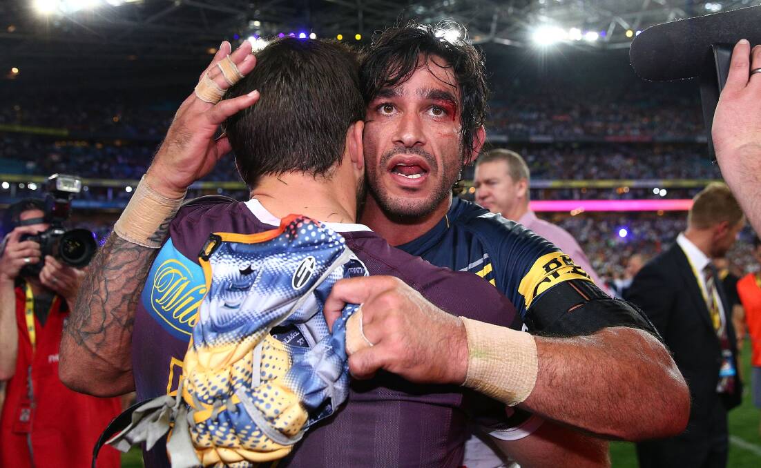 ROLE MODEL: North Queensland co-captain Johnathan Thurston consoles Brisbane's Ben Hunt after an inspirational performance for the Cowboys in their NRL grand final victory. Picture: Getty Images