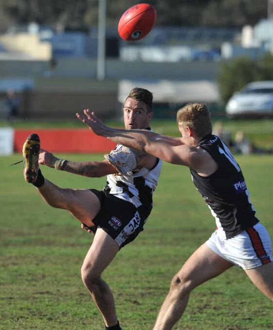 TOUGH BATTLE: The Rock-Yerong Creek forward Mitch Ward gets his kick away despite the attention of North Wagga's Brayden Skeers. Picture: Laura Hardwick