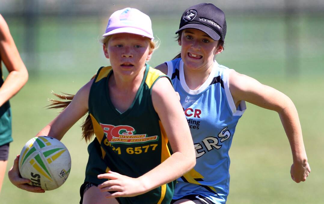 CHASING: Under 14s Strikers touch football player hot on the heels of Riverina Cranes player Georgie Holbrook. Picture: Les Smith