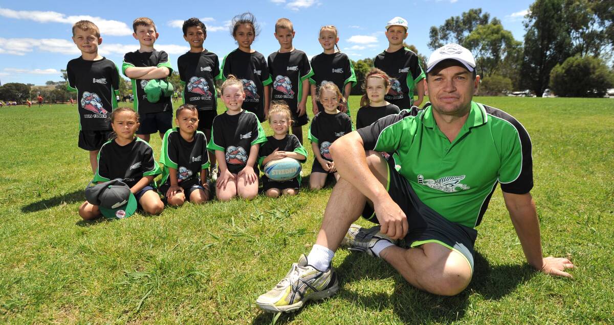 QUIETLY CONFIDENT: Coach Matt Shannon (right) and Ross C's Ducks, his daughter's under eight's touch football team at Jubilee Park on Saturday. Picture: Laura Hardwick