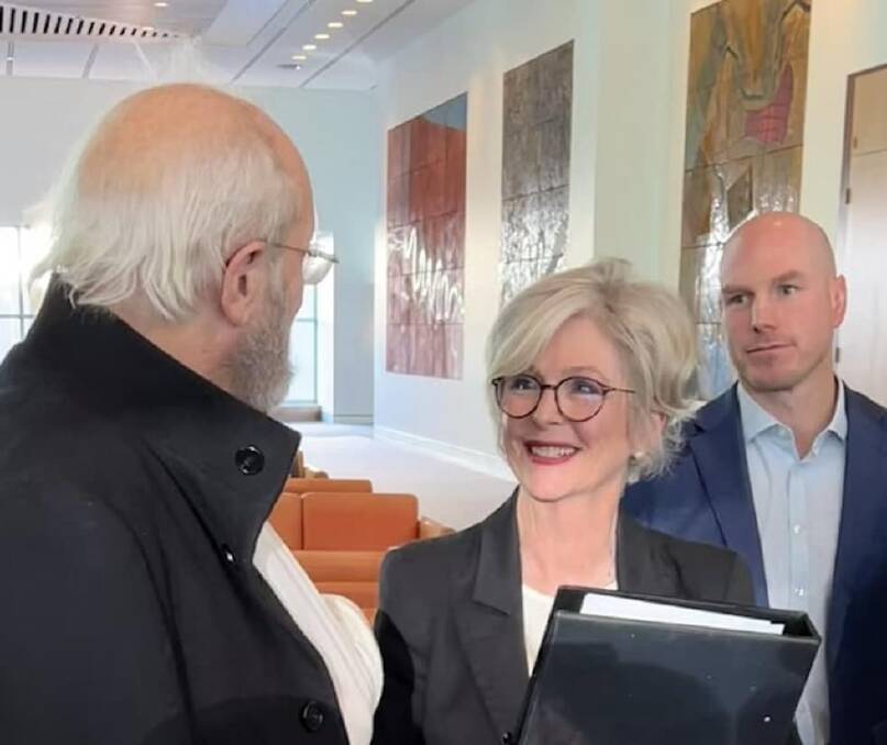 Julian Assange's father John Shiption speaks to Helen Haines in Parliament House as ACT senator David Pocock watches on. Picture from Facebook