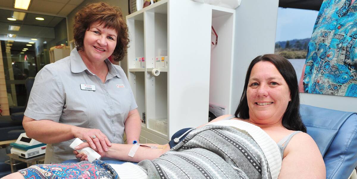 GIVING LIFE: Wagga Donor Centre registered nurse Lynden Lalic helps Kellie Simpson donate blood and boost storage levels in the city on Tuesday ahead of the October long weekend. Picture: Kieren L Tilly