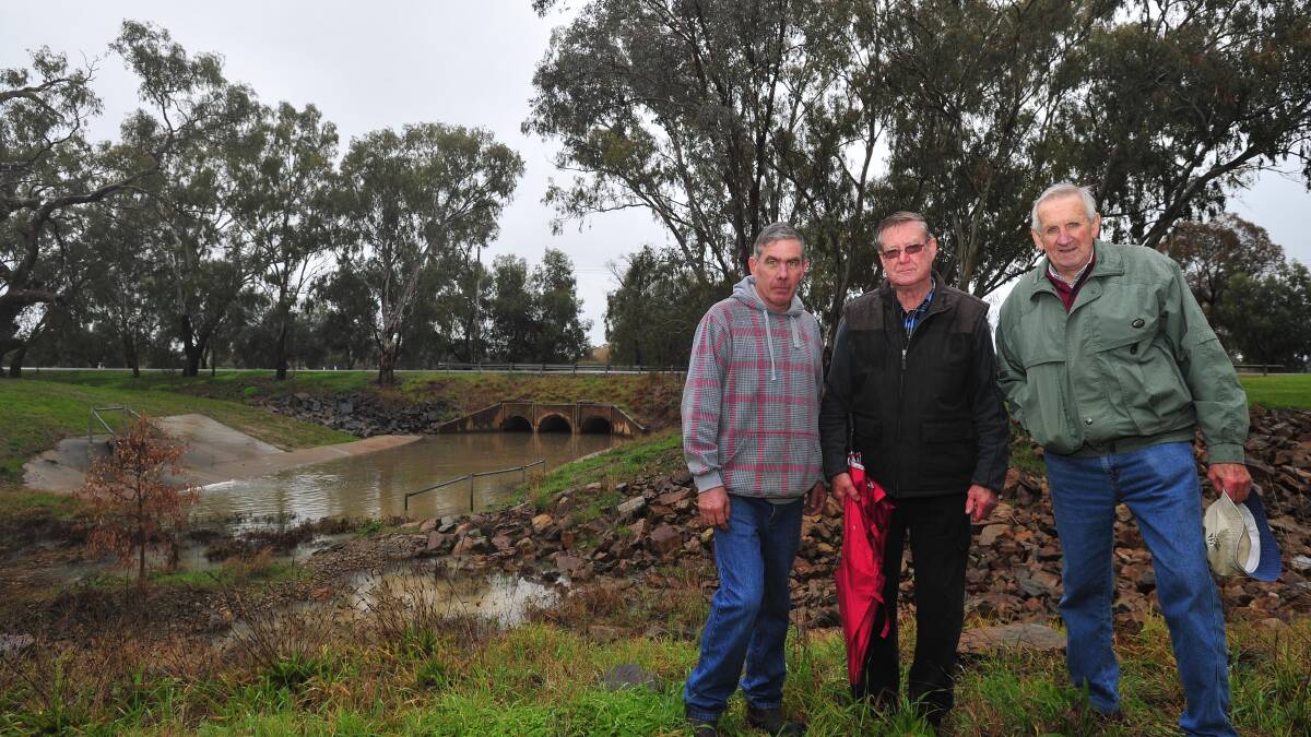 POINTING OUT THE PROBLEMS: Michael Henderson, Ron Lewington and Joe Schipp standing atop Dandaloo drain. Picture: Kieren L Tilly