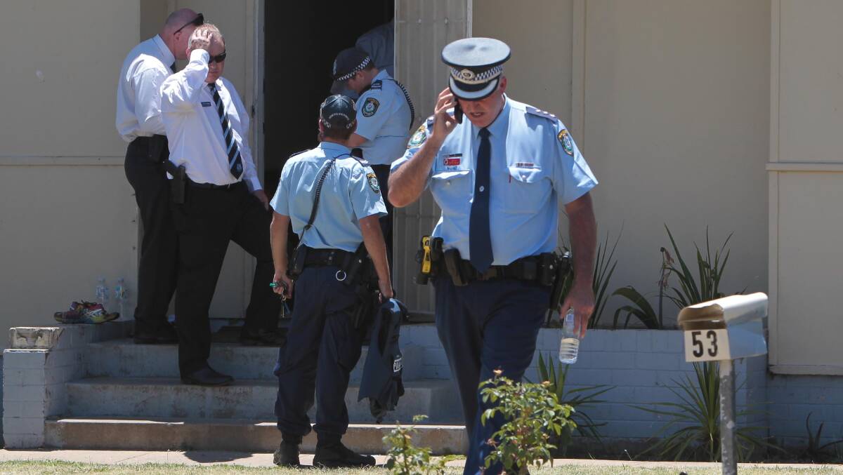 ACTION STATIONS: Wagga police swarm a McKell Avenue home after reports of shots fired. Picture: Les Smith
