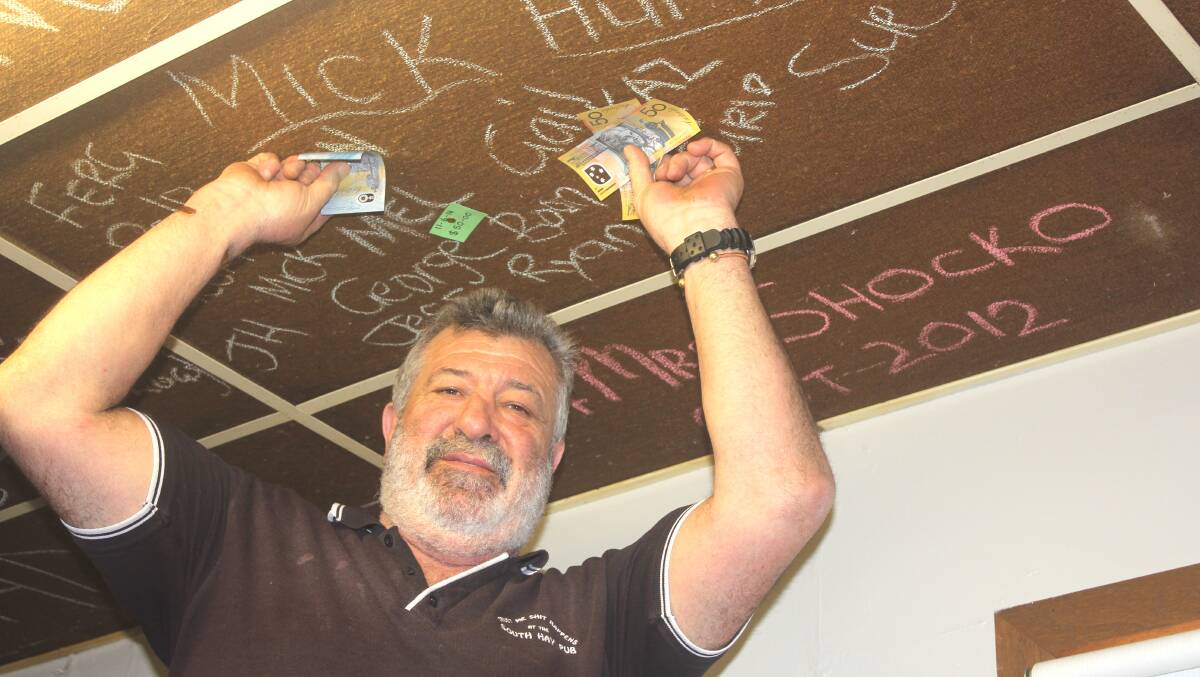 LOW BLOW: South Hay Hotel publican Ed Vitucci with the ceiling that was stripped bare of charity donations after a break-in. Picture: Chris Huntly