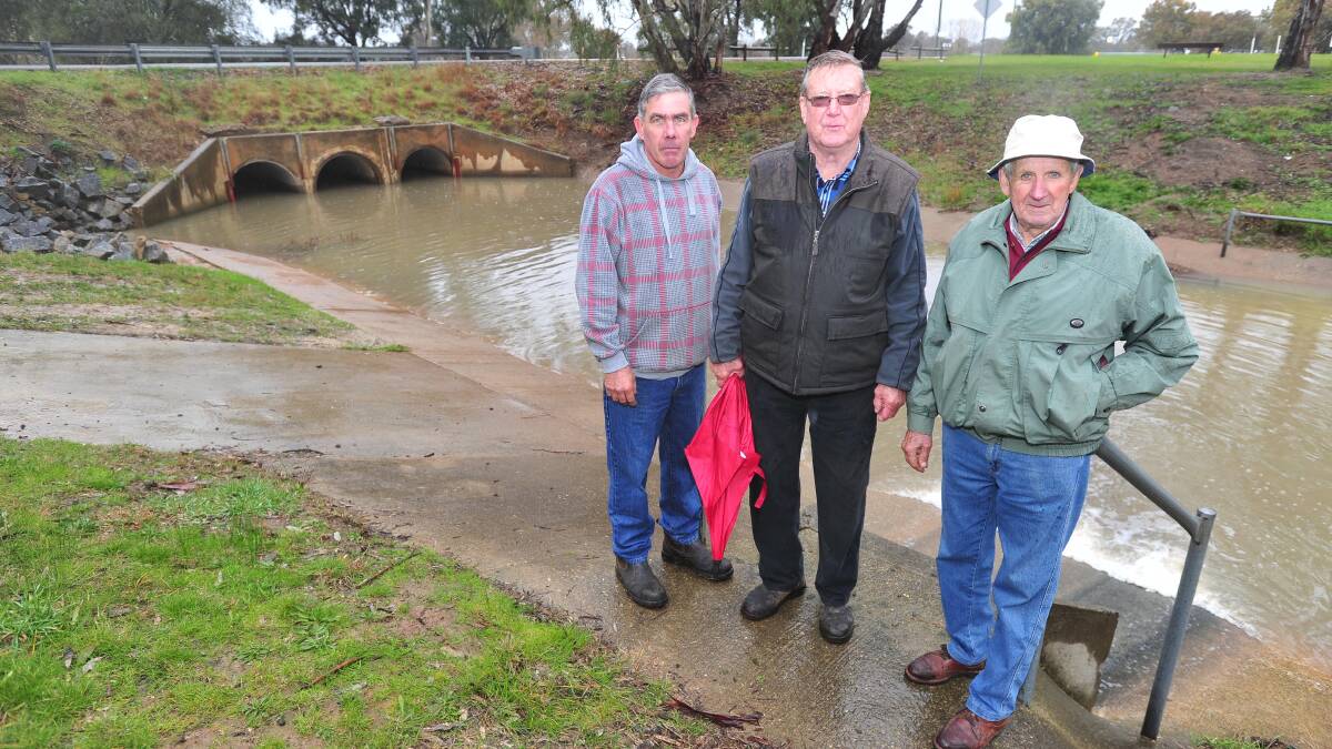 POINTING OUT THE PROBLEMS: Michael Henderson, Ron Lewington and Joe Schipp standing atop Dandaloo drain. Picture: Kieren L Tilly