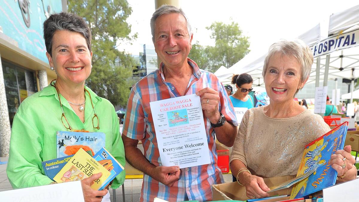 BARGAIN: Car boot sale committee president Penny Lamont and member Graham McKenzie with specialist palliative care council chair Kay Hull. Picture: Kieren L Tilly