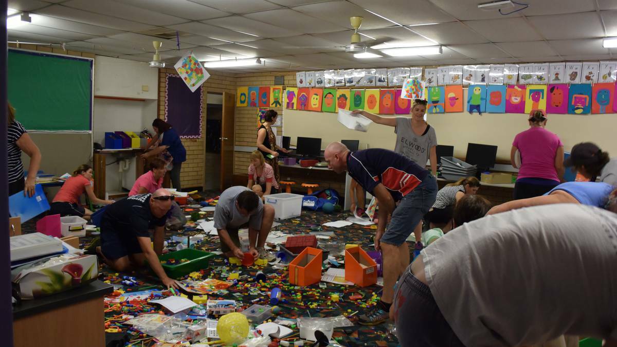 Parents and teachers clean up after vandals trashed Holy Trinity Public School earlier this month. Picture: Olivia Shying