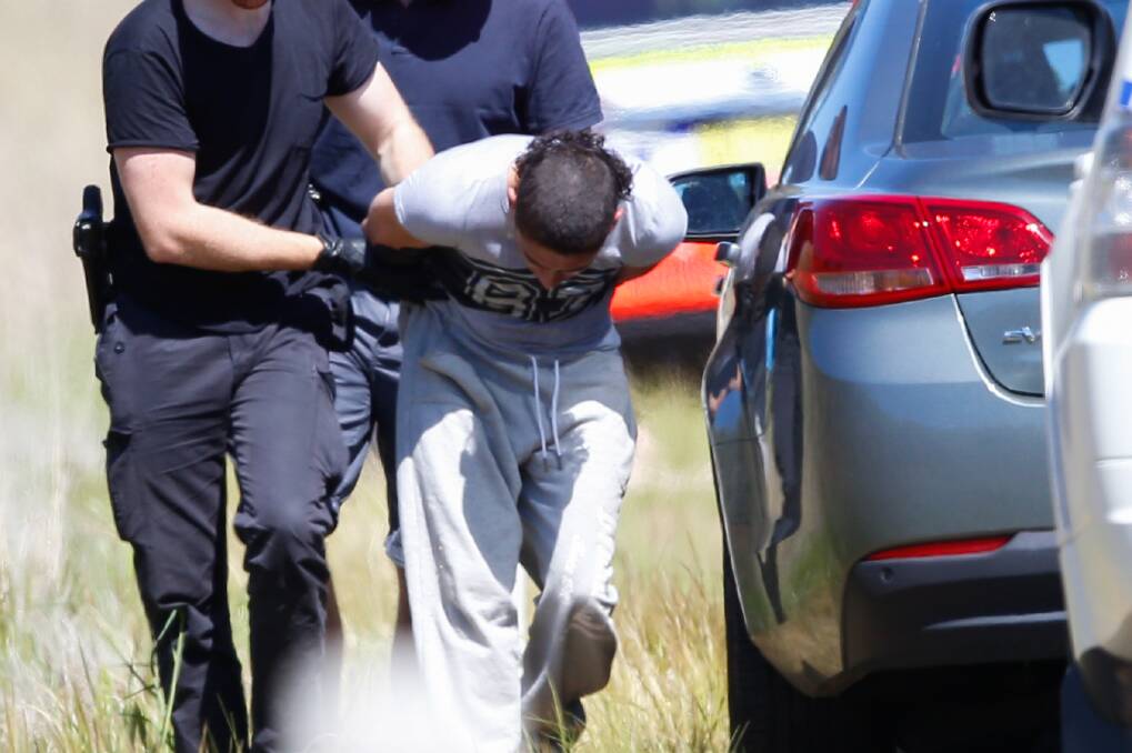 DRAMATIC ARREST: A man is taken into custody on the side of the Hume Highway at Table Top on Wednesday. Picture: MARK JESSER