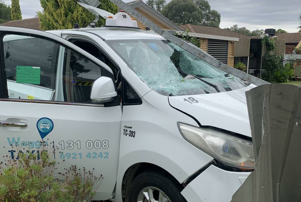 A Wagga taxi driver lost control of his cab and ploughed through the fence of a Forest Hill home, narrowly escaping serious injury. Pictures by Conor Burke, supplied 