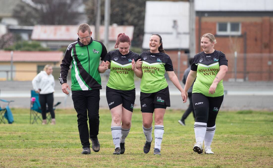 Injured South Wagga player Sophie Shephard (second from left) is helped off the field by coach Stephen Burns and teammates Jasmine Kefford and Katelyn Worldon in their Madden Shield game against Temora at Wagga Showground. Picture by Madeline Begley