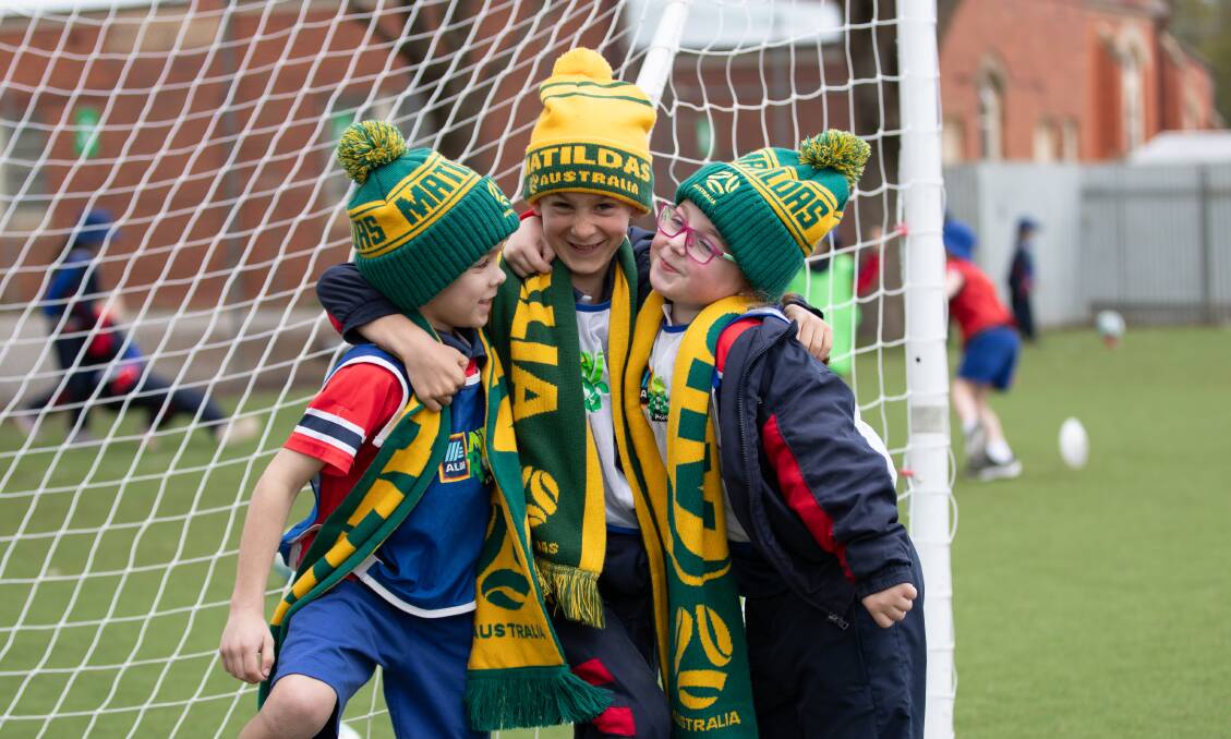 Year 1 students Nicholas Cullen, Patrick Looney and Alice Pulver, all 7, from Wagga's St Joseph's Primary School, are excited to watch the Matildas play in the FIFA Women's World Cup semi-final. Picture by Madeline Begley