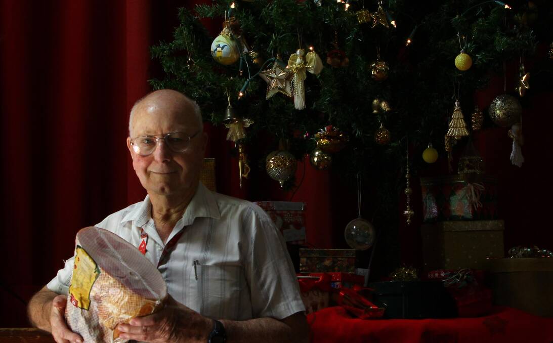 SHARING THE LOVE: Wesley Uniting Church volunteer co-ordinator Phil Sheather with one of the hams which will be plated for Christmas lunch on Friday. Picture: Les Smith