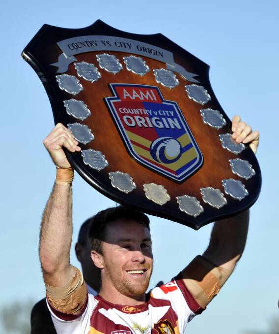 EXTRA GLORY: Country captain and man of the match James Maloney lifts up the shield following his team's 34-22 in front of a packed at Equex Centre on Sunday. Picture: Les Smith