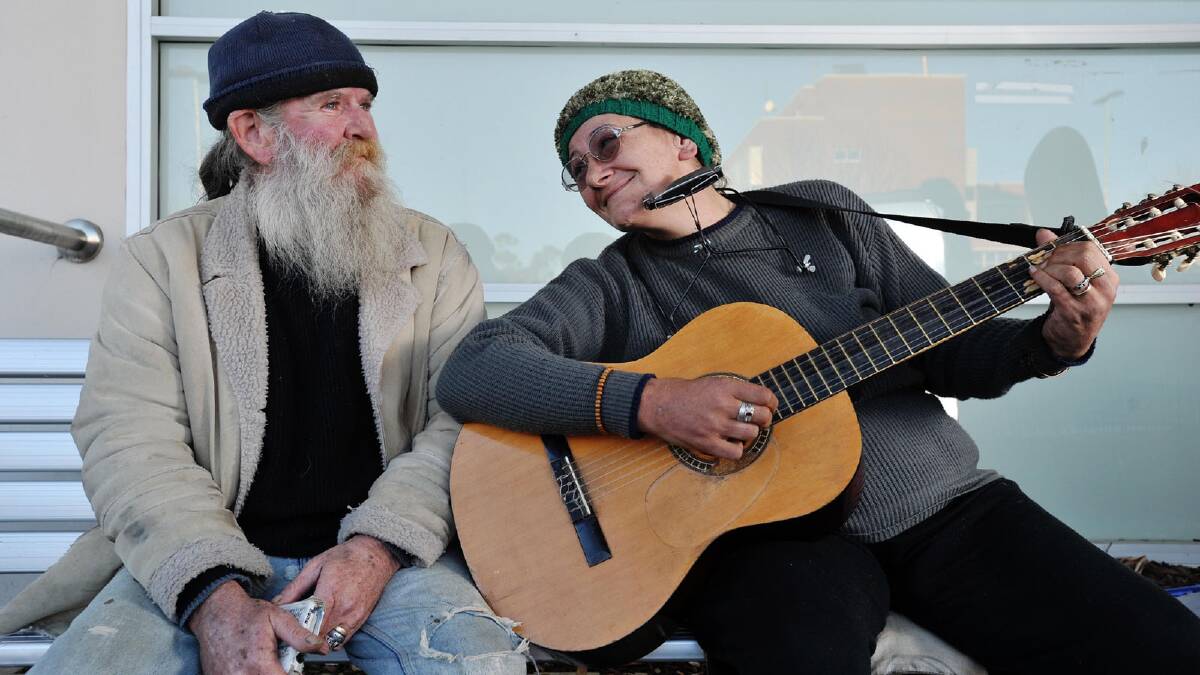 Ted and Tania McAlister are homeless and busk outside Woolworths. Picture: Alastair Brook