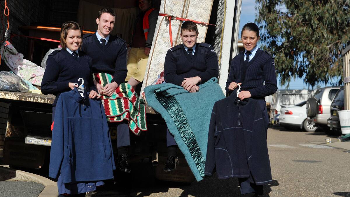 ACW Jessica Brinkworth, AC Kieran Lorrimar, AC Jordan Munro, ACW Charmaine Peebles help unload warm clothes, clean mattresses and blankets for Operation Winter Warmth at the Salvation Army. Picture: Alastair Brook