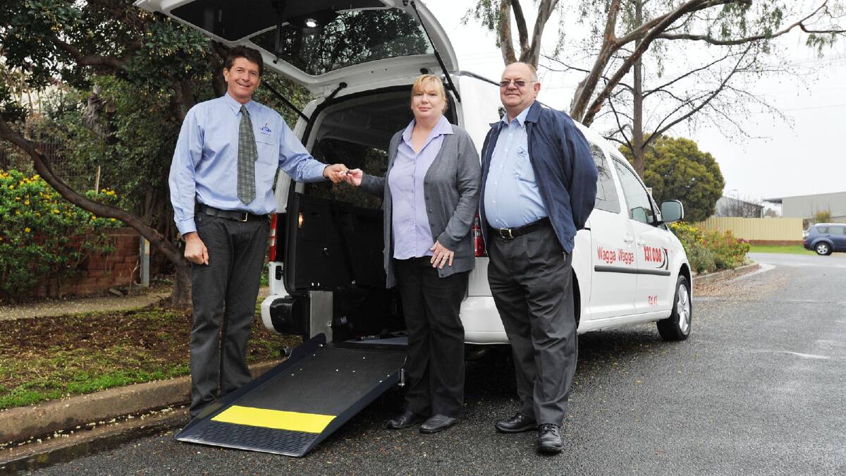(From left) director of Flashcabs Australia John Cooper, fleet manager Tanya Stubbs and chairman of Wagga Taxis John Collins welcome a new type of disabled access to Flashcabs in Wagga. Picture: Alastair Brook
