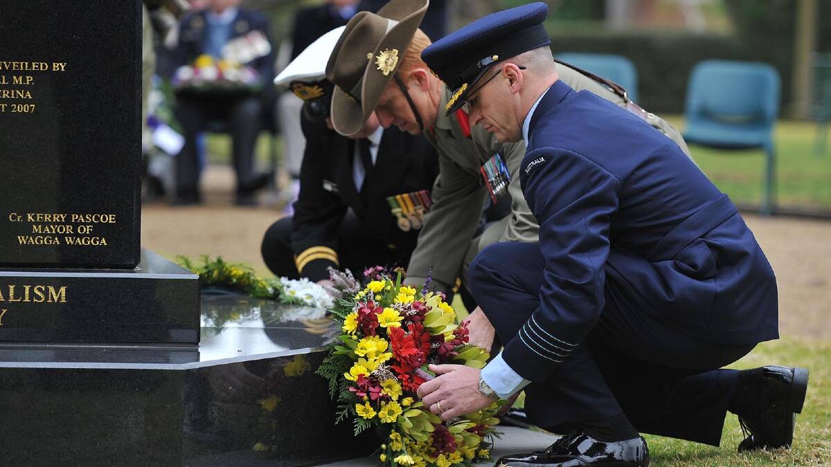 Navy's LEUT Kingsley Longman, ARMY COL David Hay and RAAF GPCPT Tony Checker laying wreaths at the ceremony.