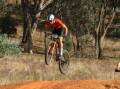 Canberra ORC's Eddie Mungoven gets some air during his race at the AusCycling Marathon National Championships held at Pomingalarna Mountain Bike Park. Picture by Bernard Humphreys
